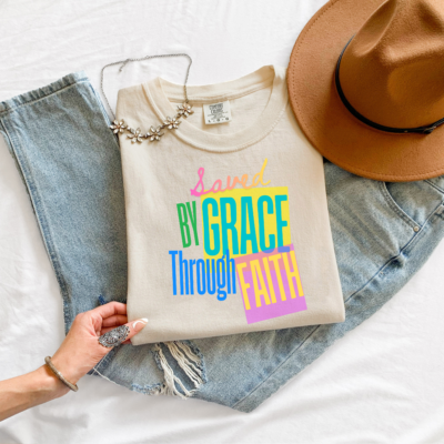 Saved by Grace Through Faith tee in Ivory, folded flat lay